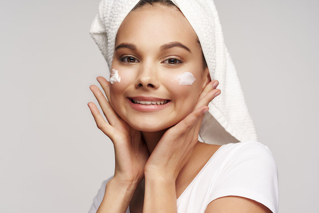 Cheerful woman with a towel on her head cosmetics clean skin 