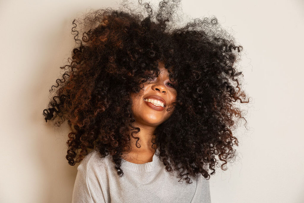 Beautiful woman with rich and long curly hair